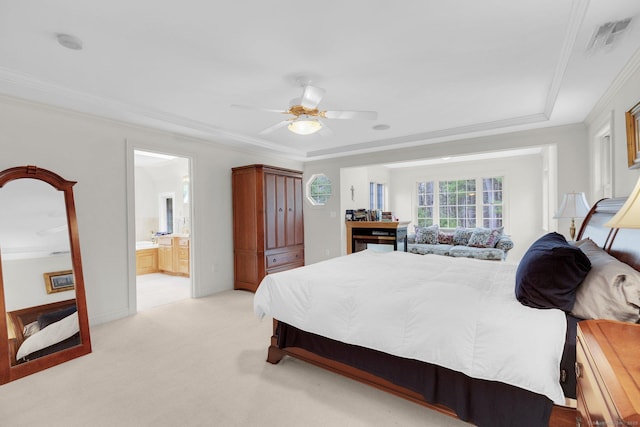 bedroom with visible vents, ornamental molding, light carpet, a ceiling fan, and ensuite bath