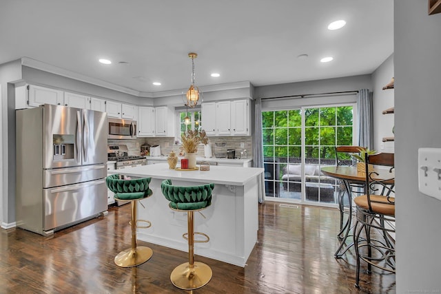 kitchen featuring appliances with stainless steel finishes, light countertops, white cabinetry, decorative backsplash, and dark wood-type flooring