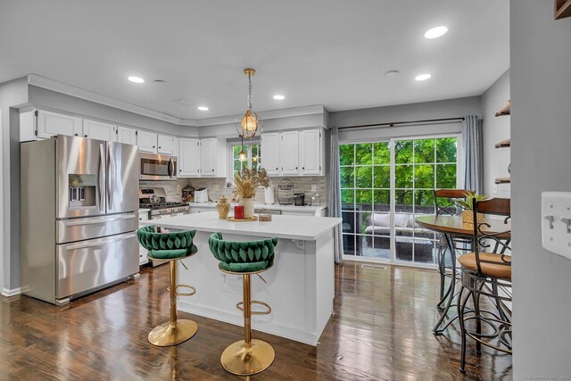37 Lakeview Ave, Shelton, CT 06484 - kitchen featuring appliances with stainless steel finishes, light countertops, white cabinetry, decorative backsplash, and dark wood-type flooring