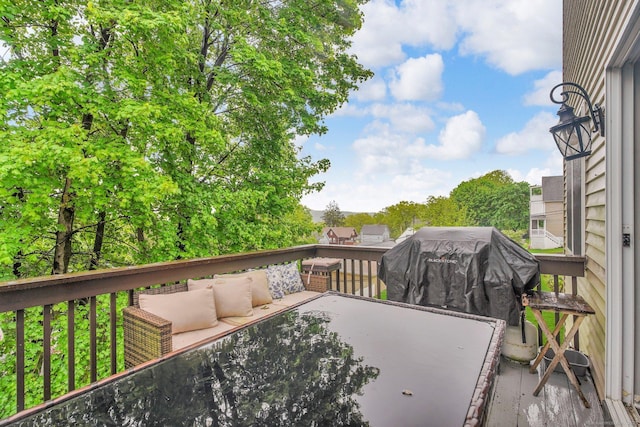 wooden deck featuring an outdoor hangout area and a grill