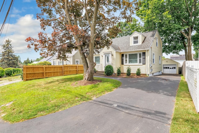 84 Oxford St, Bridgeport, CT 06606 - view of front of house with asphalt driveway, a garage, roof with shingles, and an outbuilding