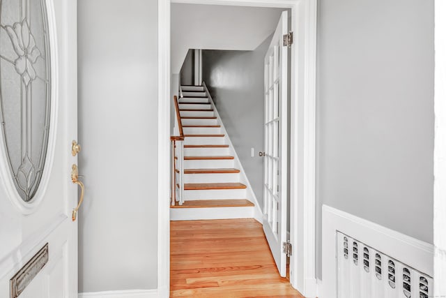 84 Oxford St, Bridgeport, CT 06606 - foyer entrance featuring light wood-type flooring, stairway, and radiator