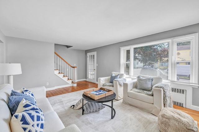 84 Oxford St, Bridgeport, CT 06606 - living room with wood finished floors, stairs, and radiator