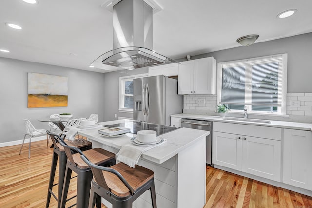 84 Oxford St, Bridgeport, CT 06606 - kitchen with appliances with stainless steel finishes, island exhaust hood, recessed lighting, a breakfast bar, and white cabinets