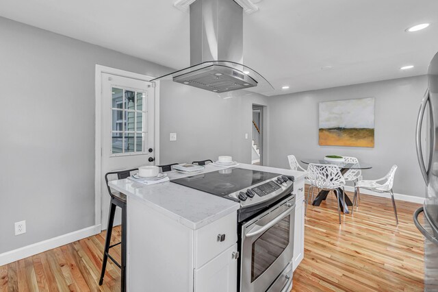 84 Oxford St, Bridgeport, CT 06606 - kitchen featuring island range hood, appliances with stainless steel finishes, recessed lighting, a kitchen island, and light wood-style floors