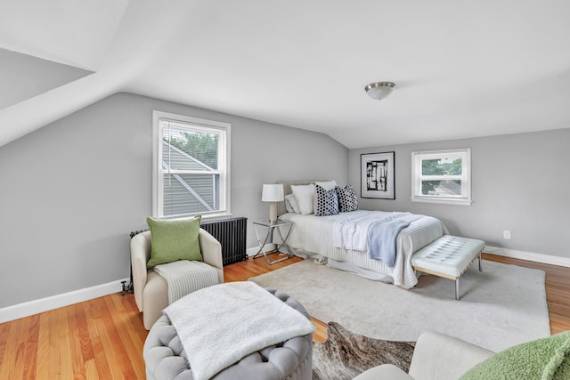 84 Oxford St, Bridgeport, CT 06606 - bedroom featuring radiator heating unit, multiple windows, lofted ceiling, and wood finished floors
