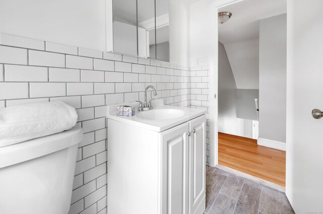 84 Oxford St, Bridgeport, CT 06606 - bathroom with vanity, wood finished floors, and tasteful backsplash