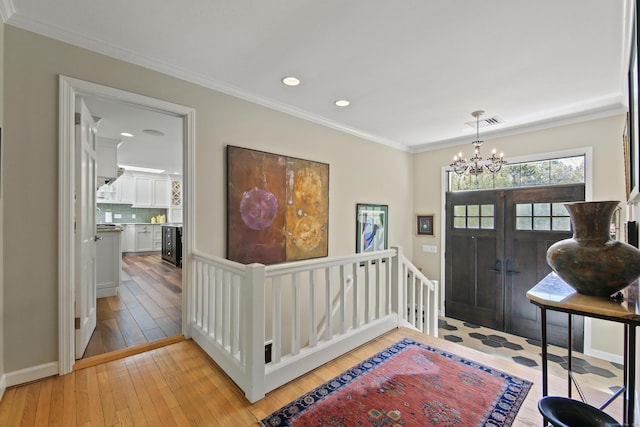 entryway featuring visible vents, crown molding, an inviting chandelier, recessed lighting, and light wood-style flooring