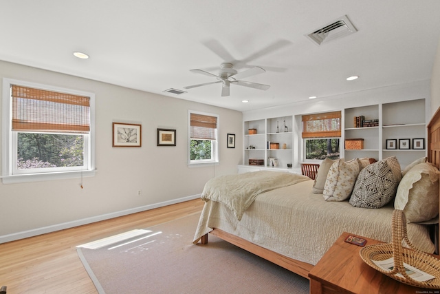 bedroom with recessed lighting, baseboards, light wood-type flooring, and visible vents