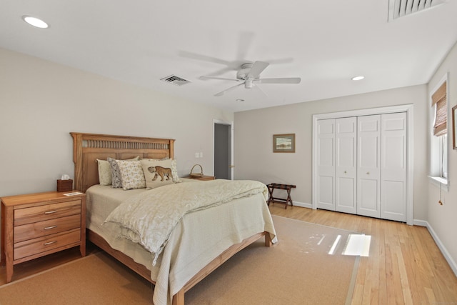 bedroom with visible vents, recessed lighting, light wood-style floors, and a closet