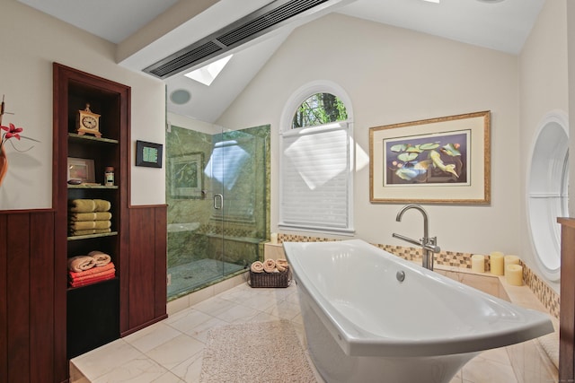 bathroom with a wainscoted wall, a soaking tub, vaulted ceiling with skylight, and a shower stall