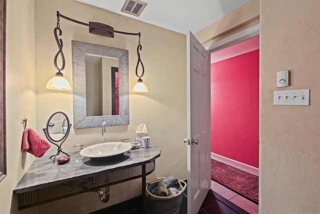 bathroom with a sink, tile patterned floors, and visible vents
