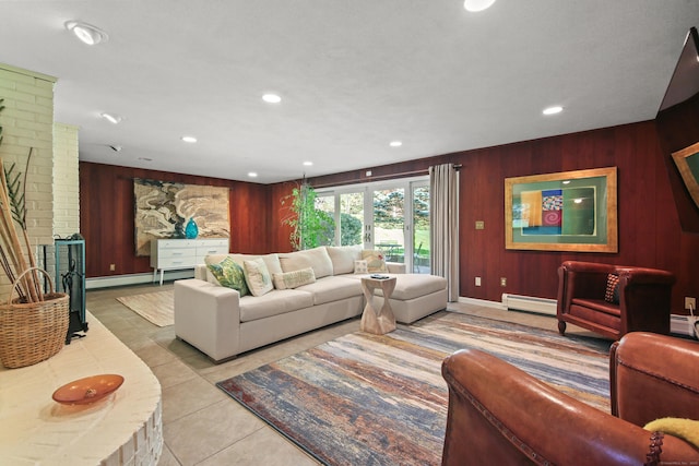tiled living room featuring recessed lighting, ornate columns, a baseboard heating unit, and wood walls