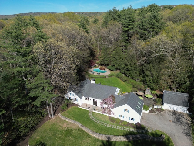 drone / aerial view featuring a forest view