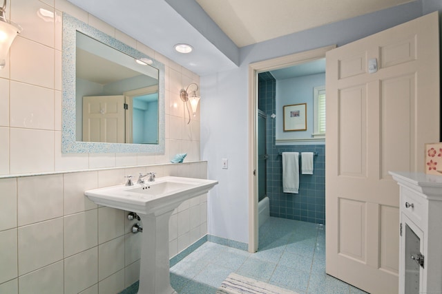 bathroom featuring shower / bathtub combination and tile walls