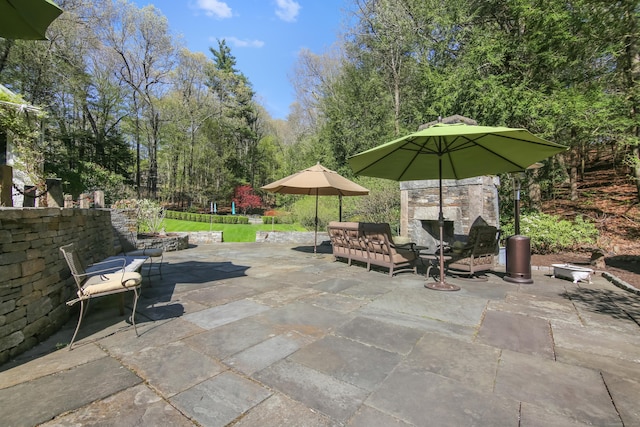 view of patio featuring exterior fireplace