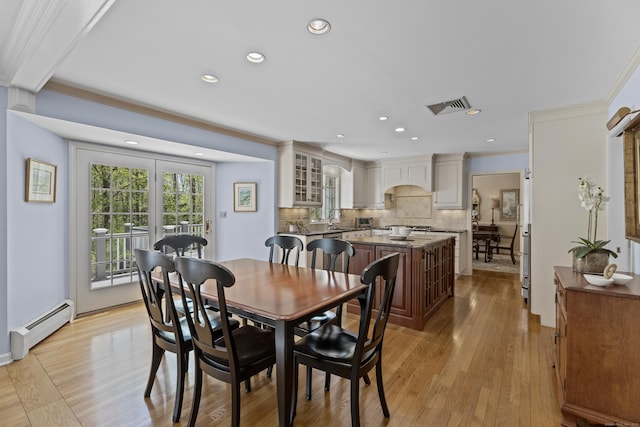 dining room with recessed lighting, visible vents, baseboard heating, and light wood-type flooring