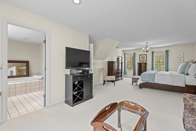 carpeted bedroom featuring an inviting chandelier, baseboards, and ensuite bathroom