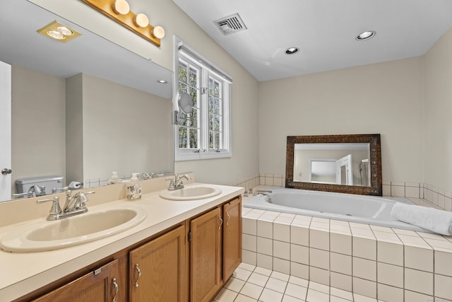 bathroom with a sink, tile patterned flooring, a jetted tub, and visible vents