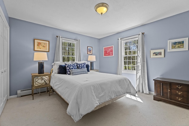 carpeted bedroom featuring baseboards, a baseboard radiator, and multiple windows