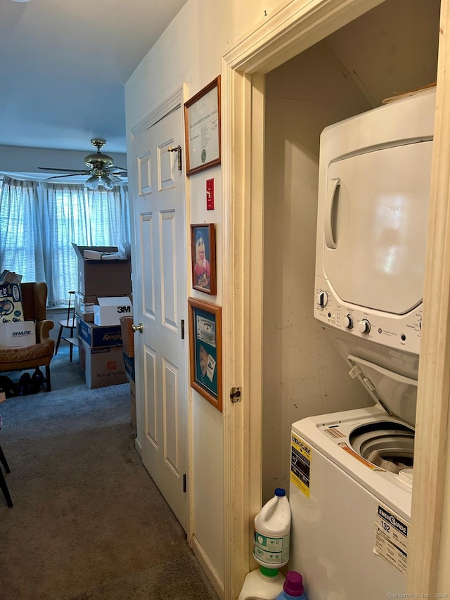 laundry area with laundry area, ceiling fan, stacked washer / drying machine, and carpet floors