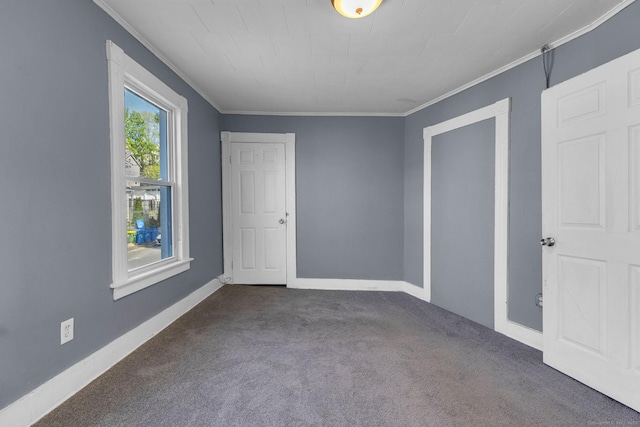 unfurnished bedroom featuring crown molding, baseboards, and carpet floors