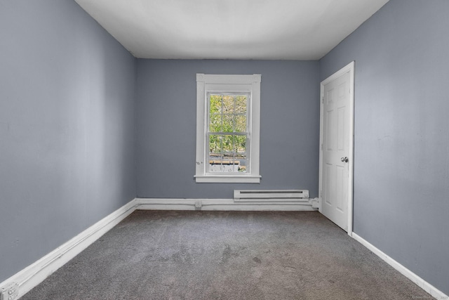 carpeted spare room with baseboards and a baseboard heating unit