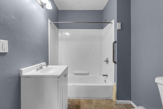 full bathroom featuring vanity, baseboards, tub / shower combination, and toilet