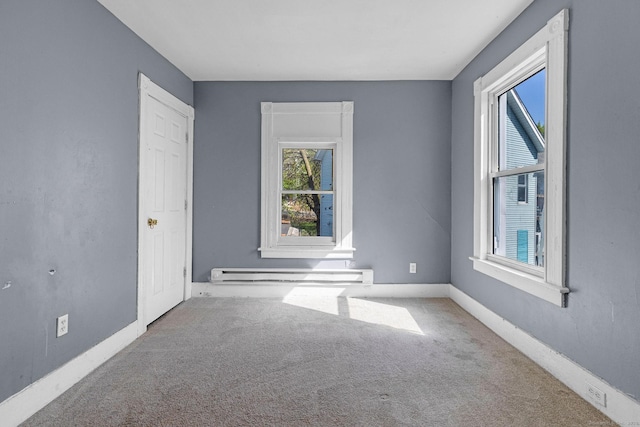 carpeted empty room with baseboards and a baseboard radiator
