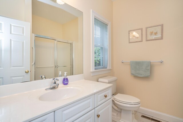 full bath featuring a shower stall, toilet, vanity, tile patterned floors, and baseboards