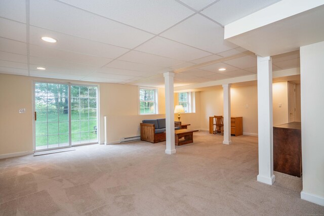 basement featuring a baseboard heating unit, carpet floors, baseboards, recessed lighting, and a paneled ceiling