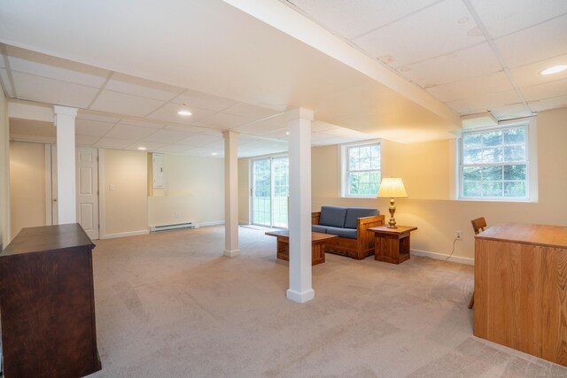 below grade area with baseboard heating, light colored carpet, baseboards, recessed lighting, and a paneled ceiling