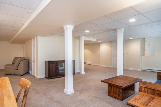 finished basement featuring light carpet, a baseboard heating unit, recessed lighting, and baseboards