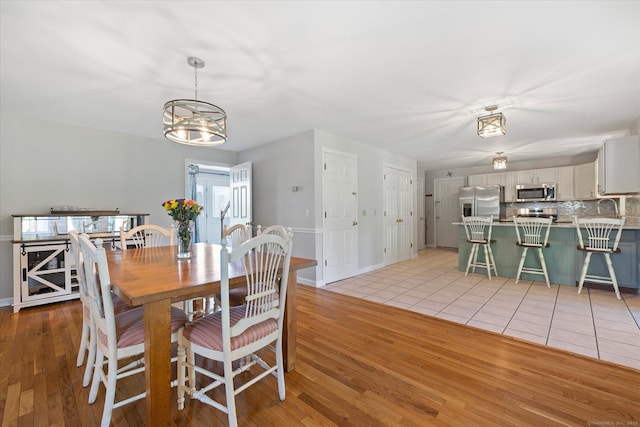 6 Margaret Cir, Pomfret, CT 06259 - dining room with baseboards, an inviting chandelier, and light wood-type flooring