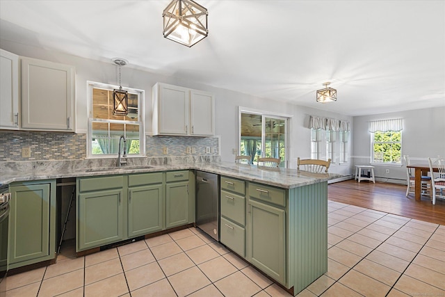6 Margaret Cir, Pomfret, CT 06259 - kitchen with stainless steel dishwasher, a peninsula, green cabinetry, a sink, and light tile patterned floors