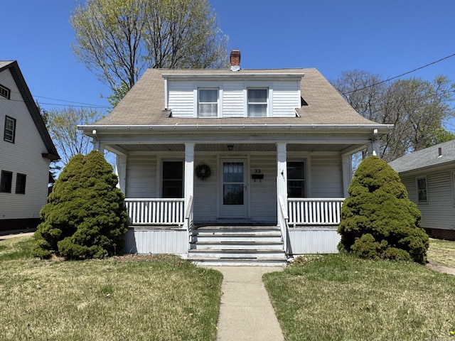 33 E Brown St, West Haven, CT 06516 - bungalow with a chimney, a porch, and a front yard