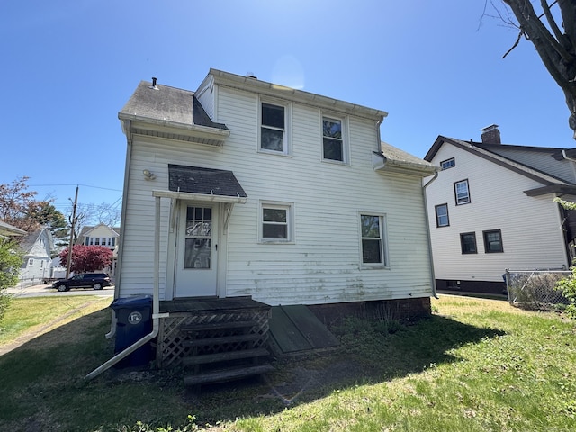 33 E Brown St, West Haven, CT 06516 - back of property featuring a lawn and roof with shingles