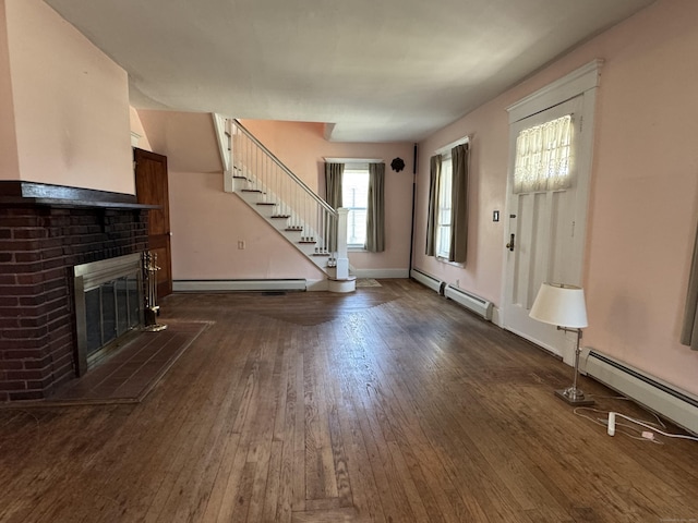 33 E Brown St, West Haven, CT 06516 - unfurnished living room featuring baseboard heating, a brick fireplace, a baseboard radiator, dark wood-style floors, and stairs