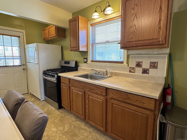 33 E Brown St, West Haven, CT 06516 - kitchen with stainless steel range with gas cooktop, brown cabinetry, and a sink