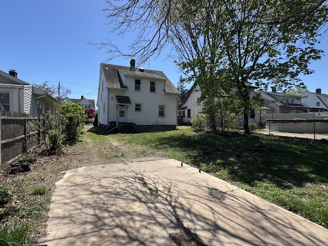 33 E Brown St, West Haven, CT 06516 - rear view of house with fence, a chimney, and a yard