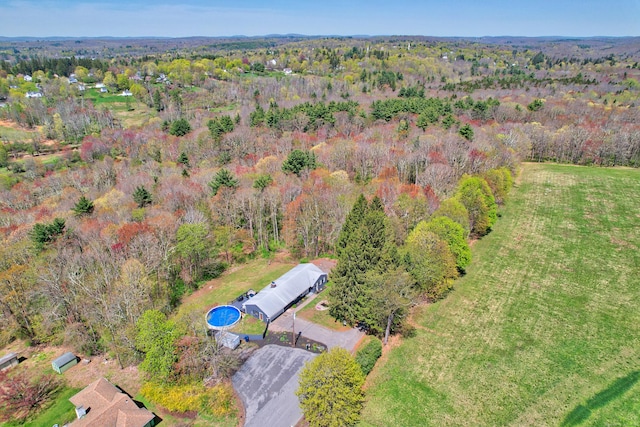 drone / aerial view featuring a forest view