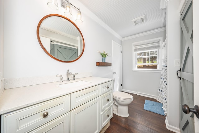 bathroom with toilet, ornamental molding, hardwood / wood-style flooring, and vanity