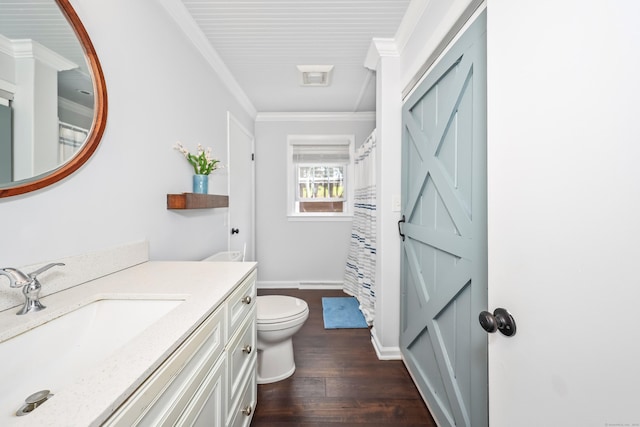 bathroom featuring vanity, toilet, baseboards, wood finished floors, and ornamental molding