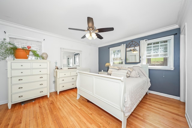 bedroom with crown molding, baseboards, and light wood-style flooring