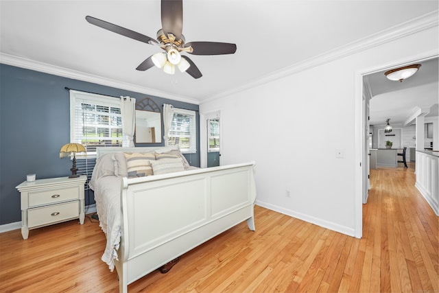 bedroom with baseboards, ornamental molding, light wood finished floors, and ceiling fan