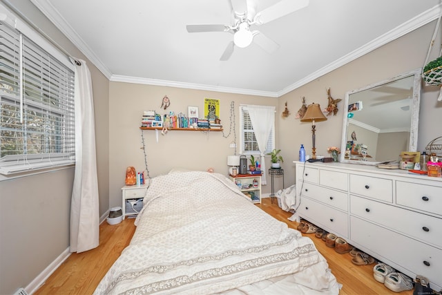 bedroom featuring crown molding, baseboards, light wood-style floors, and a ceiling fan