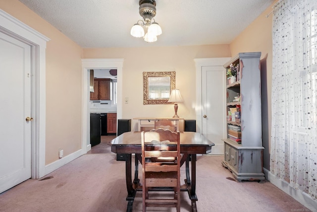 dining room featuring an inviting chandelier, baseboards, and light carpet
