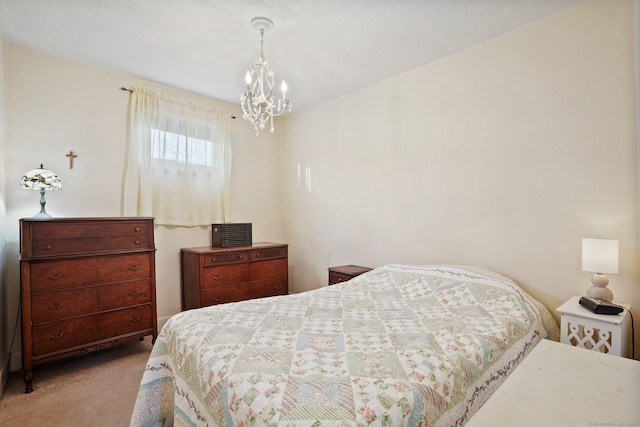 bedroom featuring an inviting chandelier and carpet
