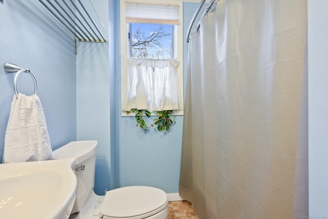 full bathroom with toilet and a shower with curtain