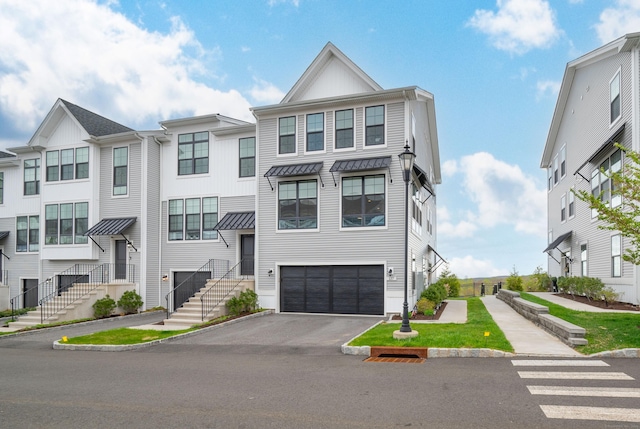 view of property with an attached garage and aphalt driveway
